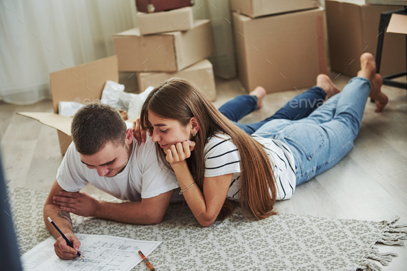 Filing Document. Cheerful Young Couple In Their New Apartment ...